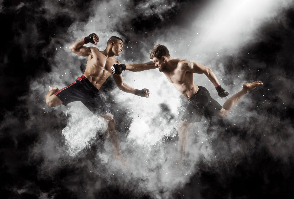 Two martial arts fighters in action on a black background.