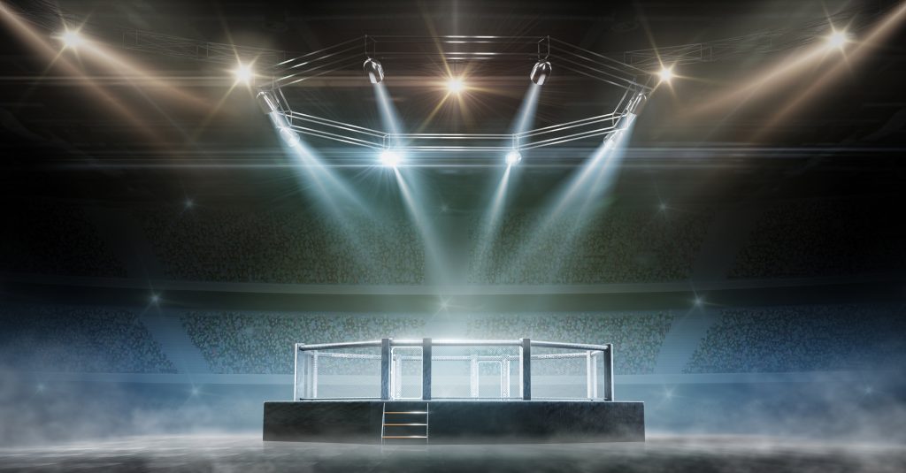 A boxing ring with spotlights in the background.