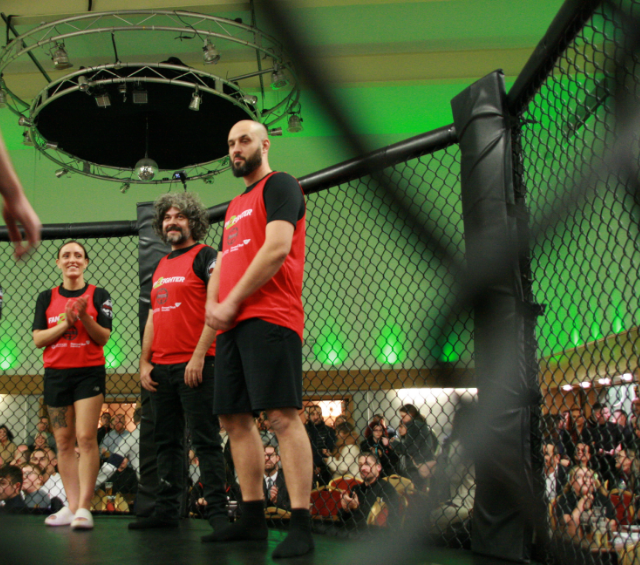 A group of people standing on top of a wrestling ring