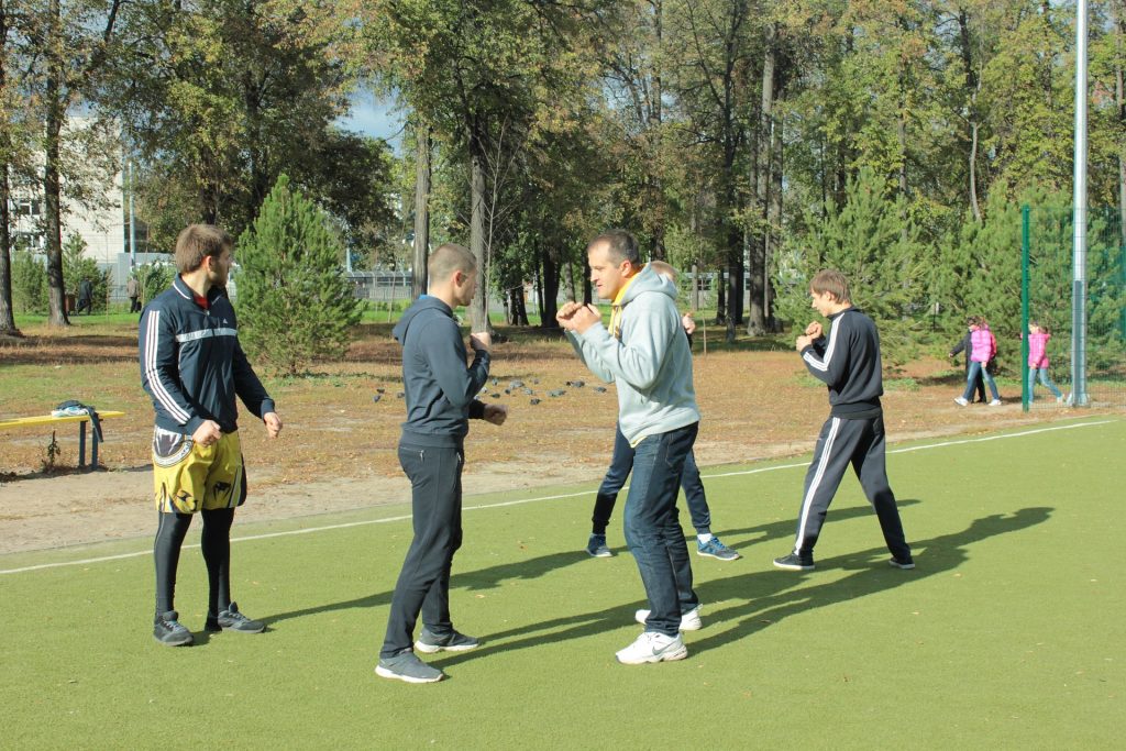 A group of people standing on top of a soccer field