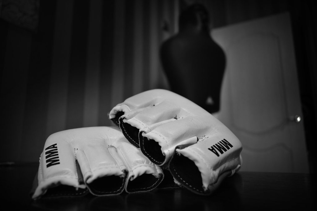 A pair of white boxing gloves on a table.