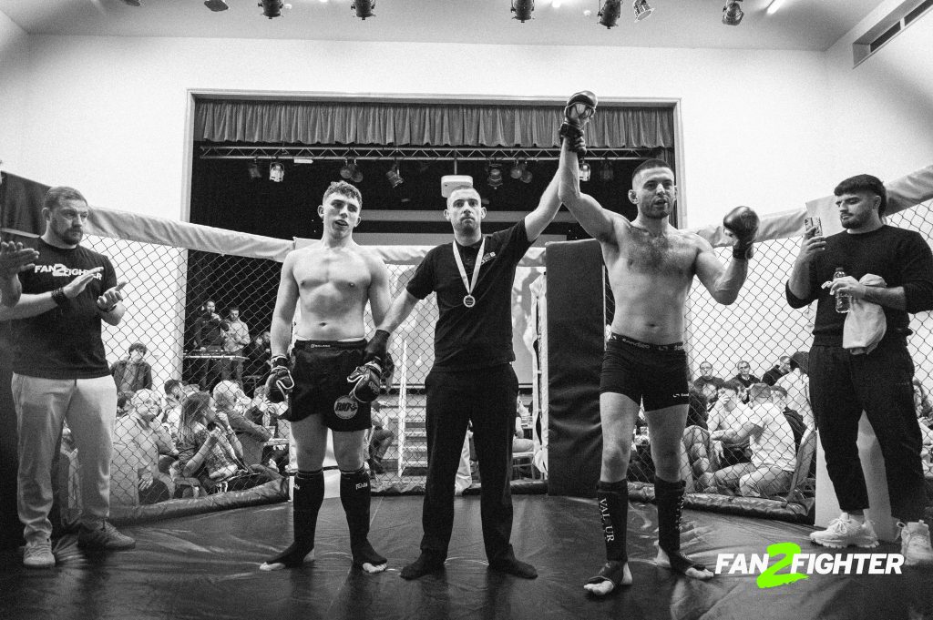 A group of men standing on top of a wrestling ring